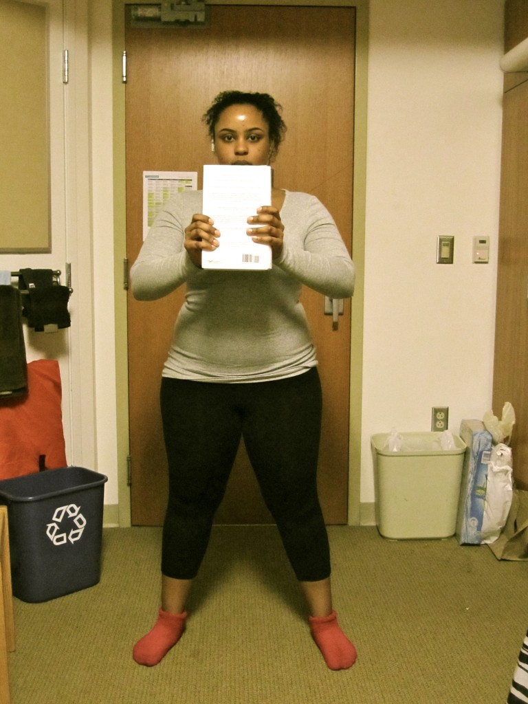 Stand with textbook in hand and feet shoulder length apart.