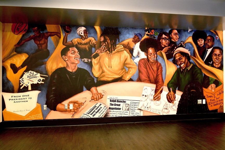 A photo of the mural displayed in the Black Bruin Resource Center. The mural depicts various Black historical figures and athletes surrounding a wooden table